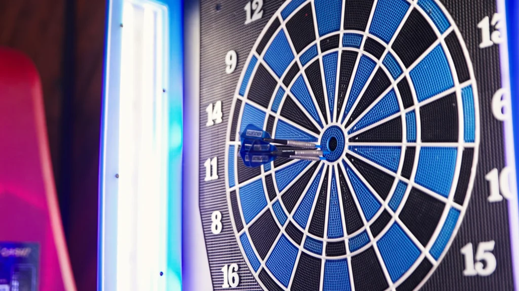 Dart Board with Black and Blue checkered boundaries. Blue dart in center of board.